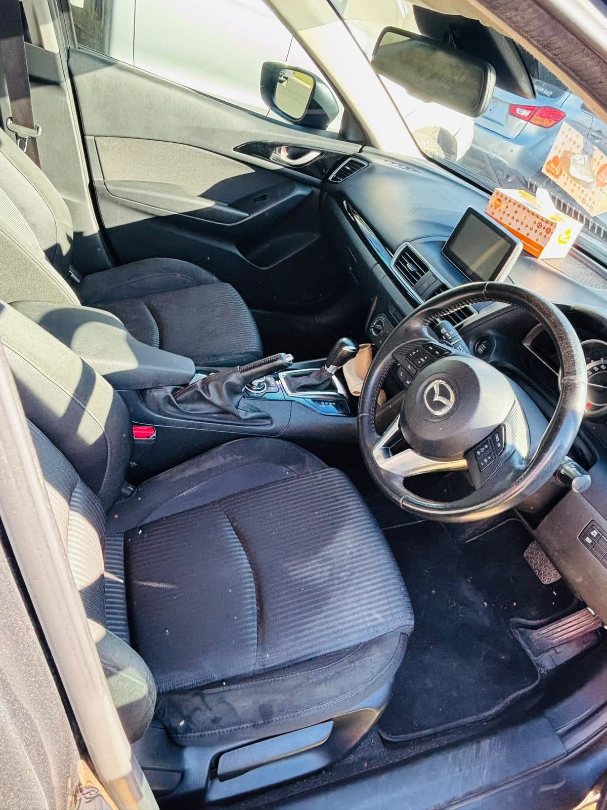 Dark grey 2013 Mazda 3 hatchback parked beside a lawn, photo 3