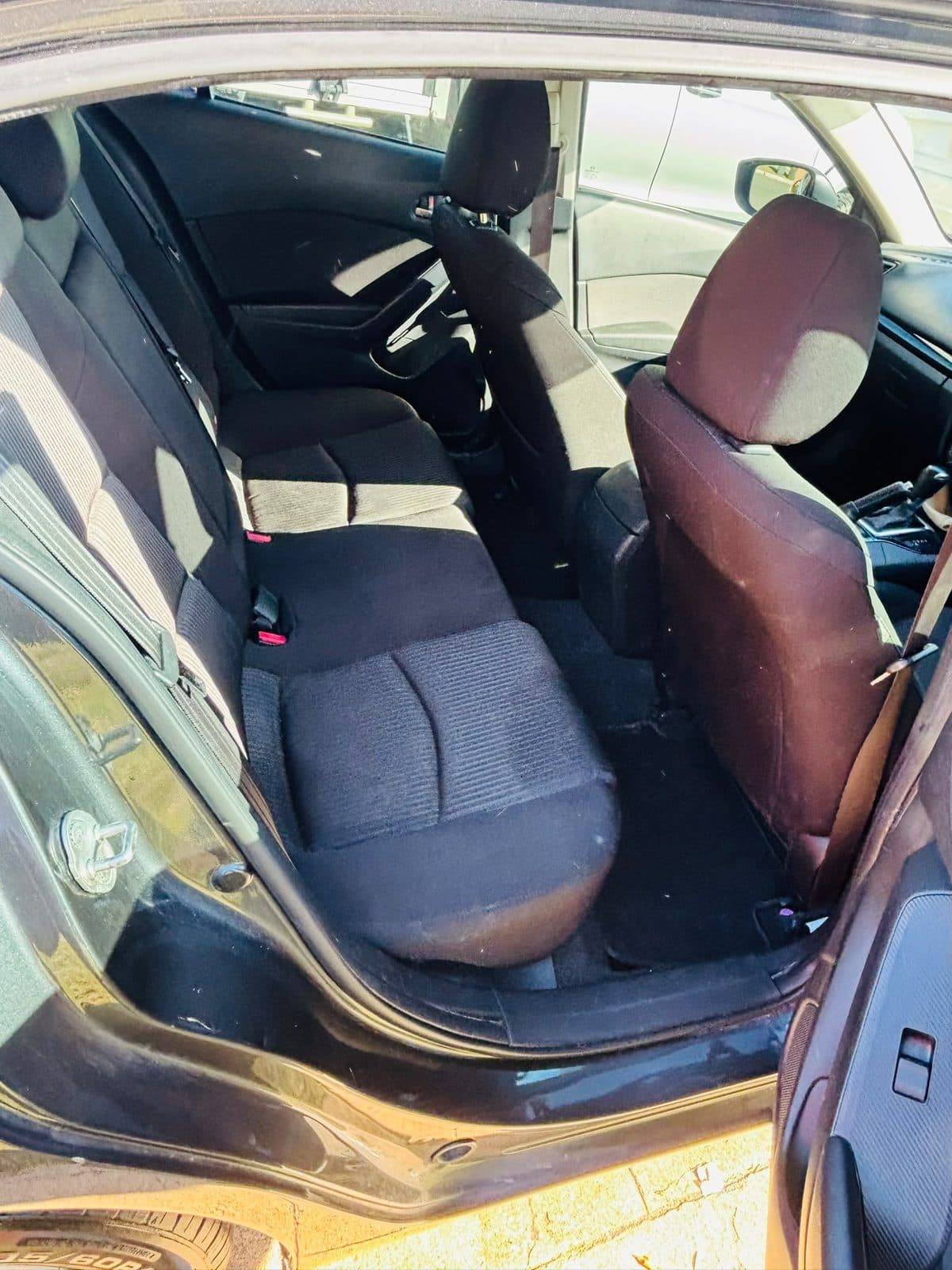 Dark grey 2013 Mazda 3 hatchback parked beside a lawn, photo 4