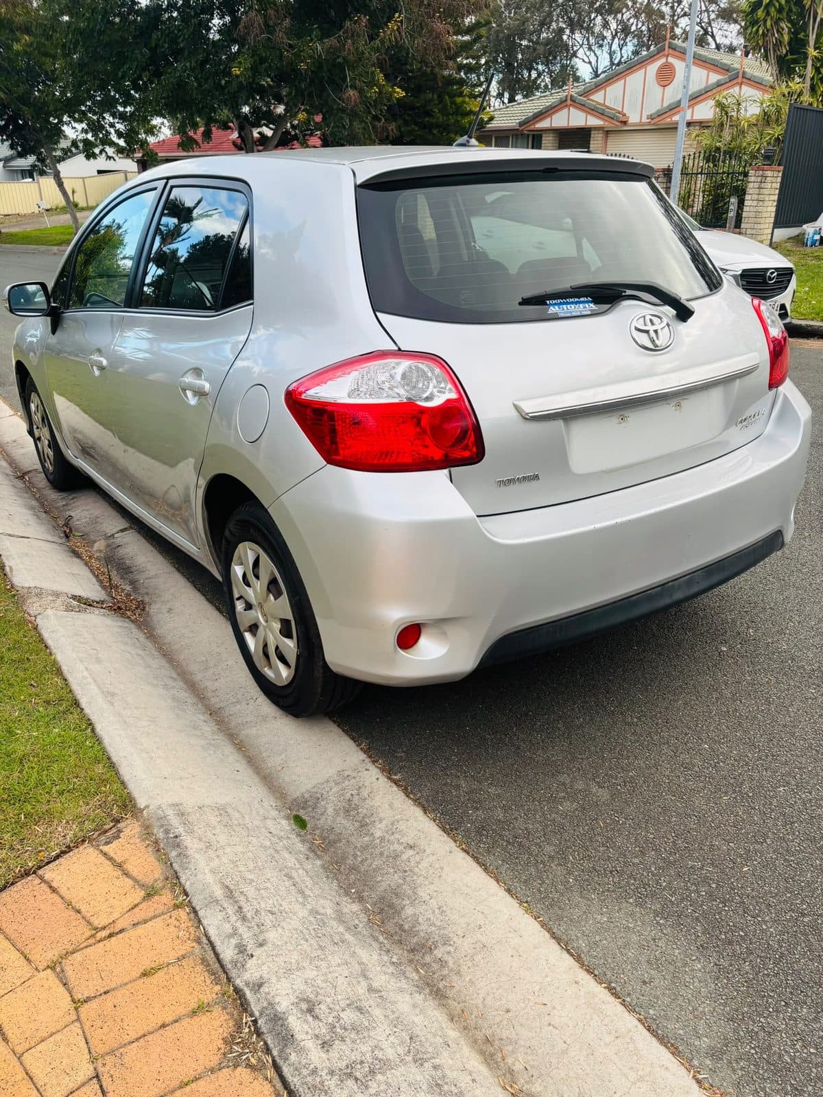 Silver 2012 Toyota Corolla hatchback parked on a residential street, photo 3