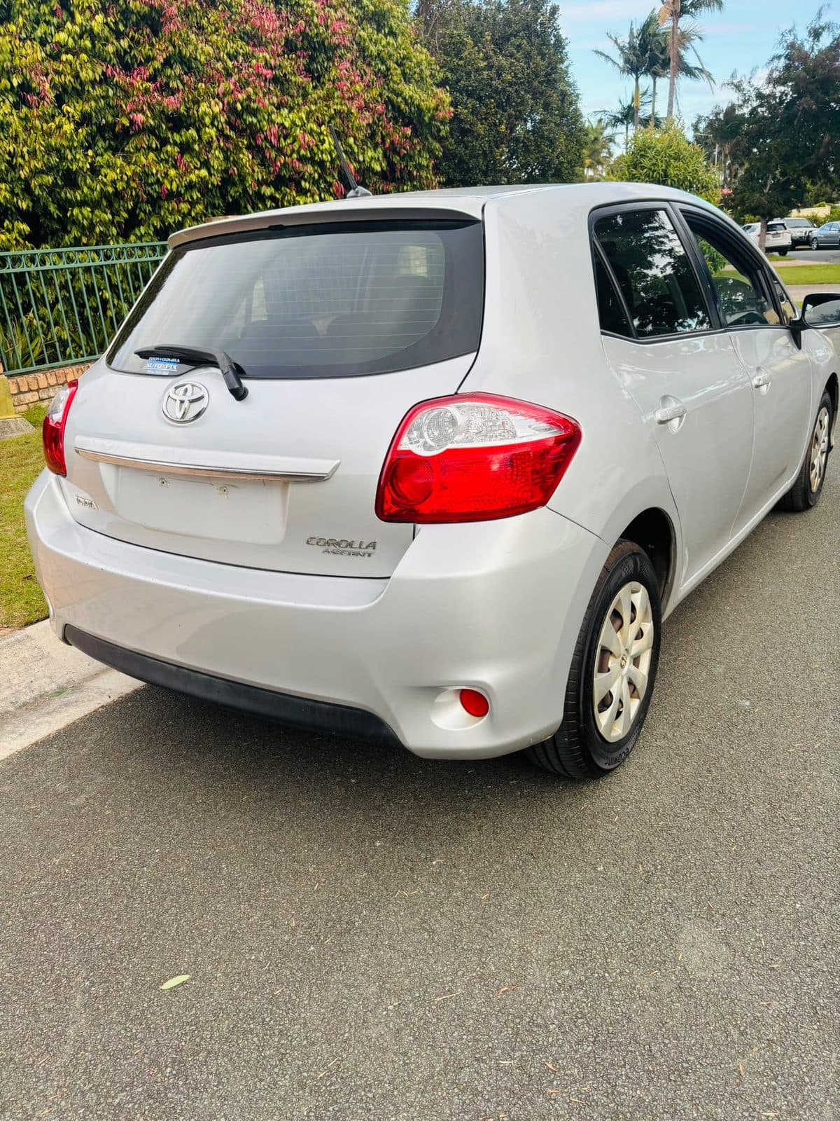 Silver 2012 Toyota Corolla hatchback parked on a residential street, photo 4
