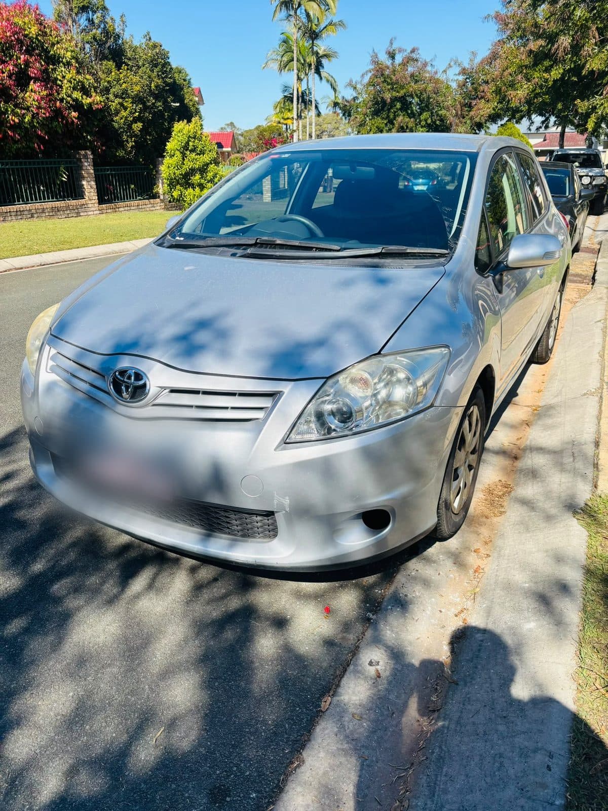 Silver 2012 Toyota Corolla hatchback parked on a residential street, photo 9