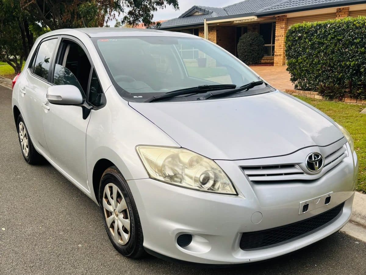 Silver 2012 Toyota Corolla hatchback parked on a residential street